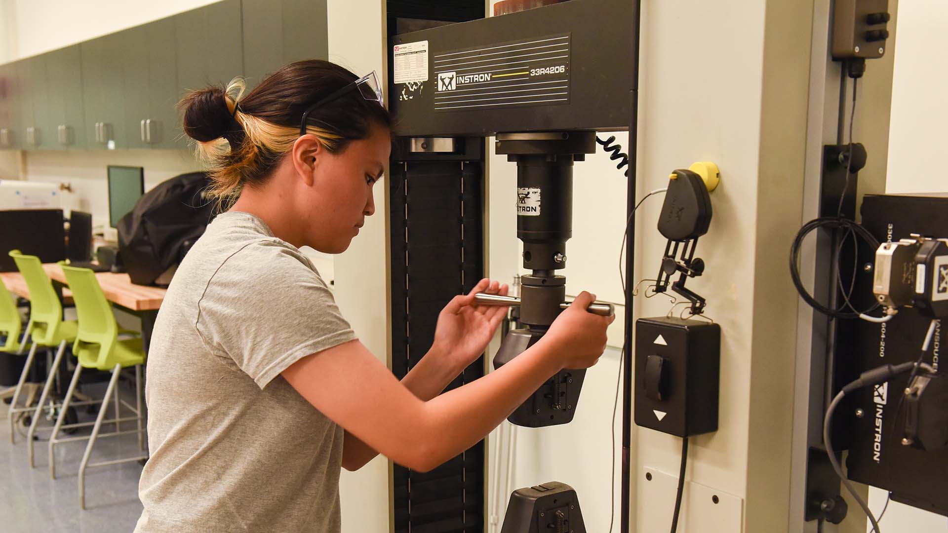 Student in working with a tool in a CGAM lab