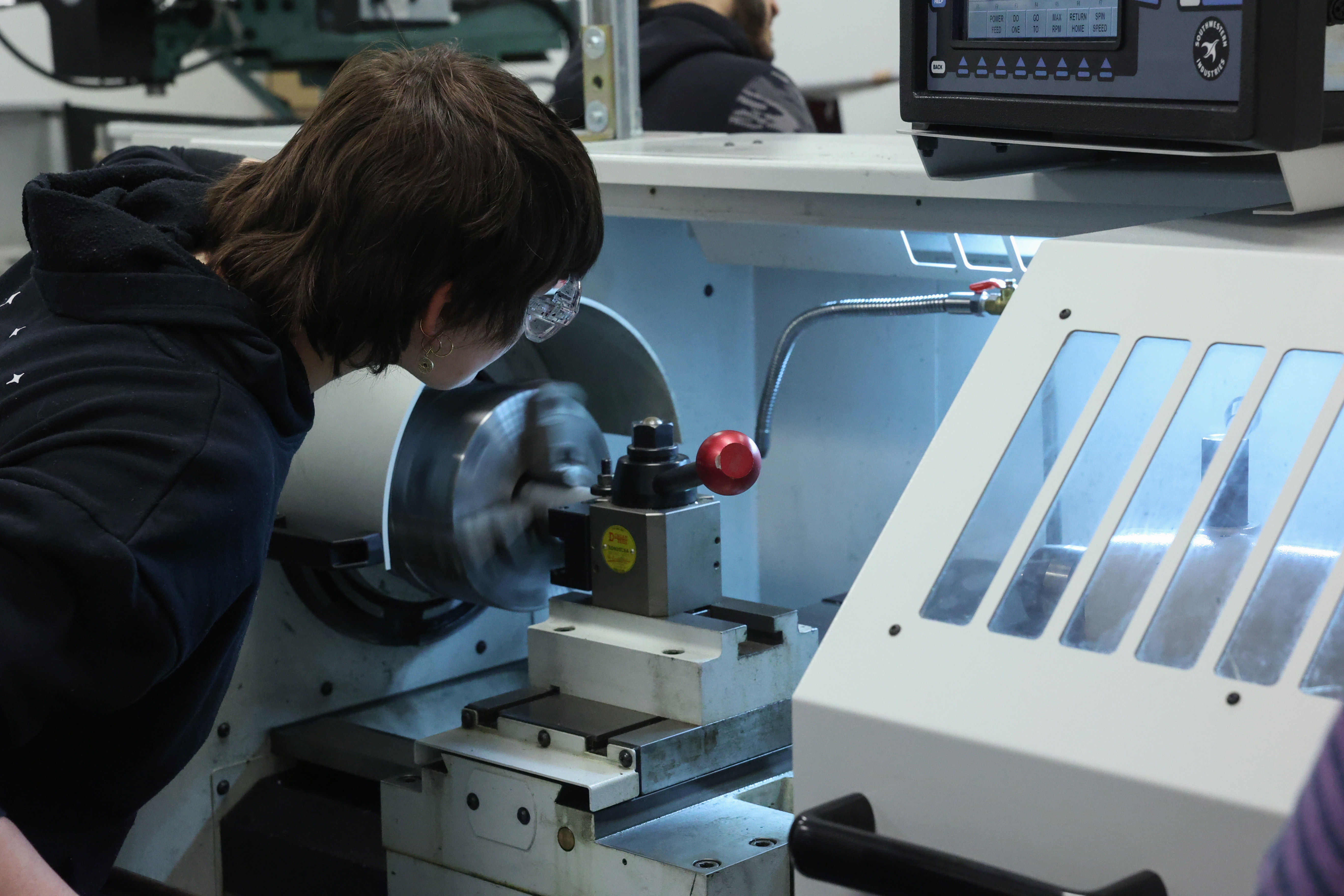 Mechanical engineering student working with lab equipment