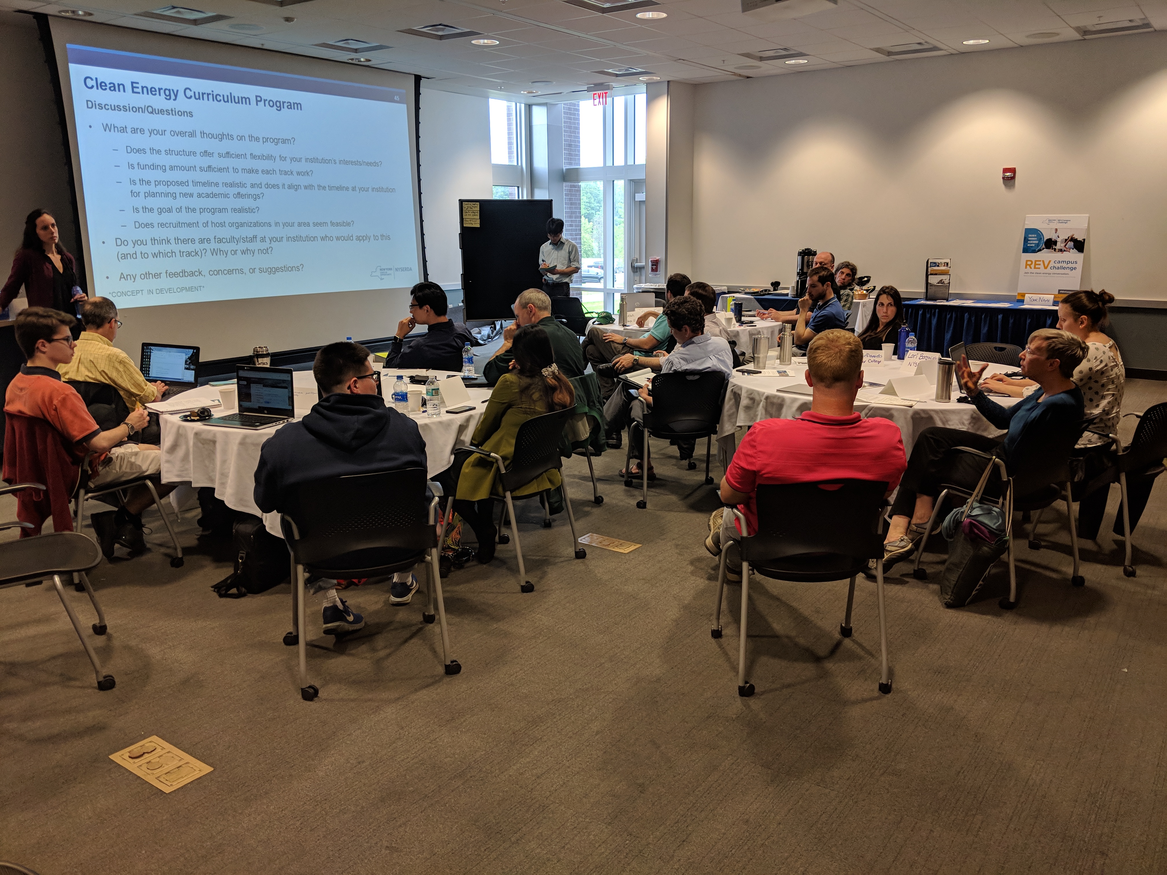 People seated discussing Clean Energy Curriculum Program