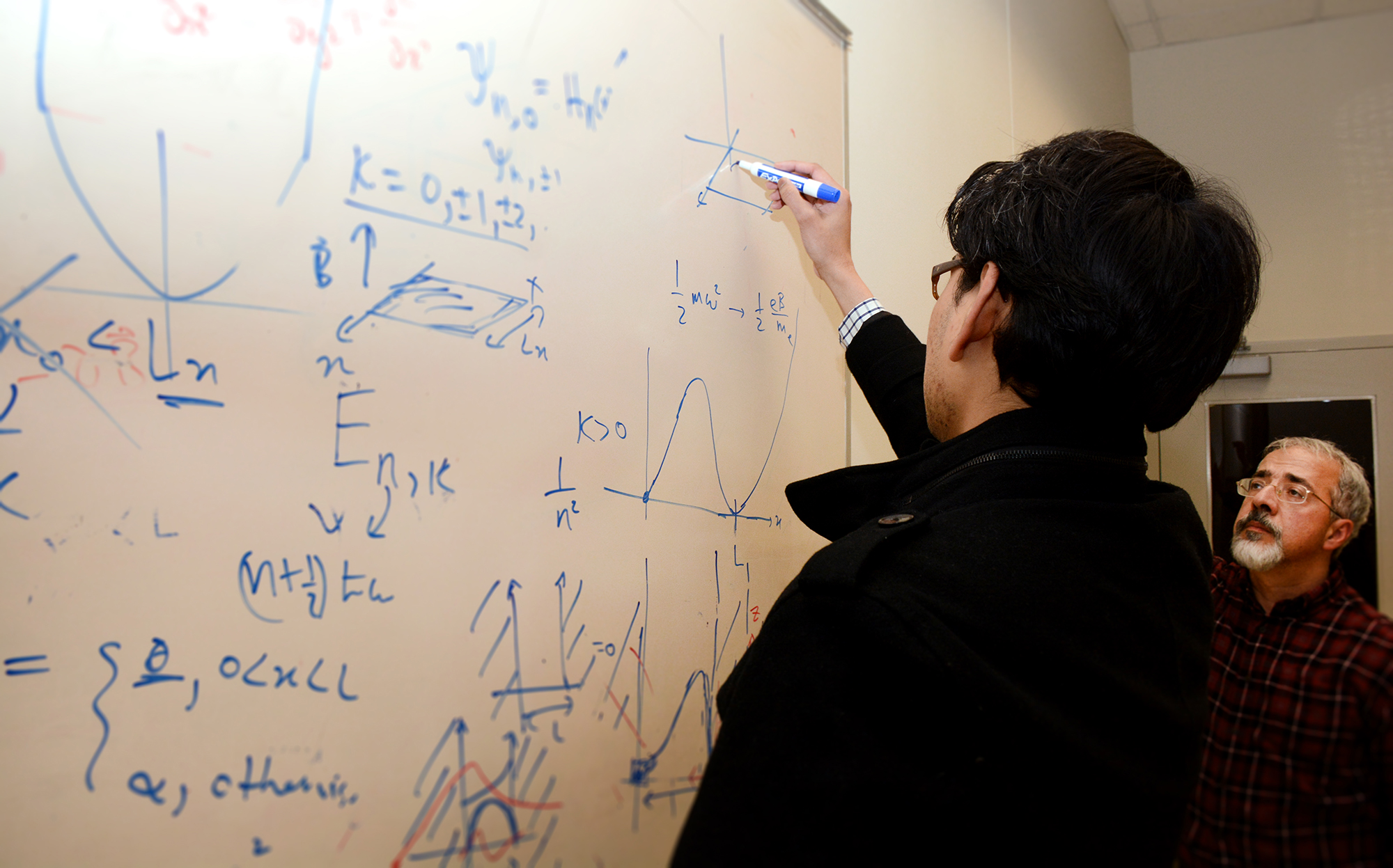 student working on dry-erase board