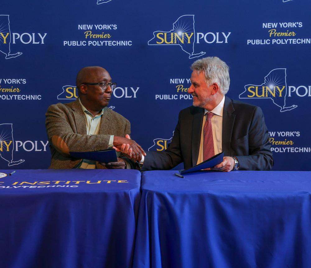 Dr. Soboyejo (left) and Dr. Trolio shake hands after signing an agreement.