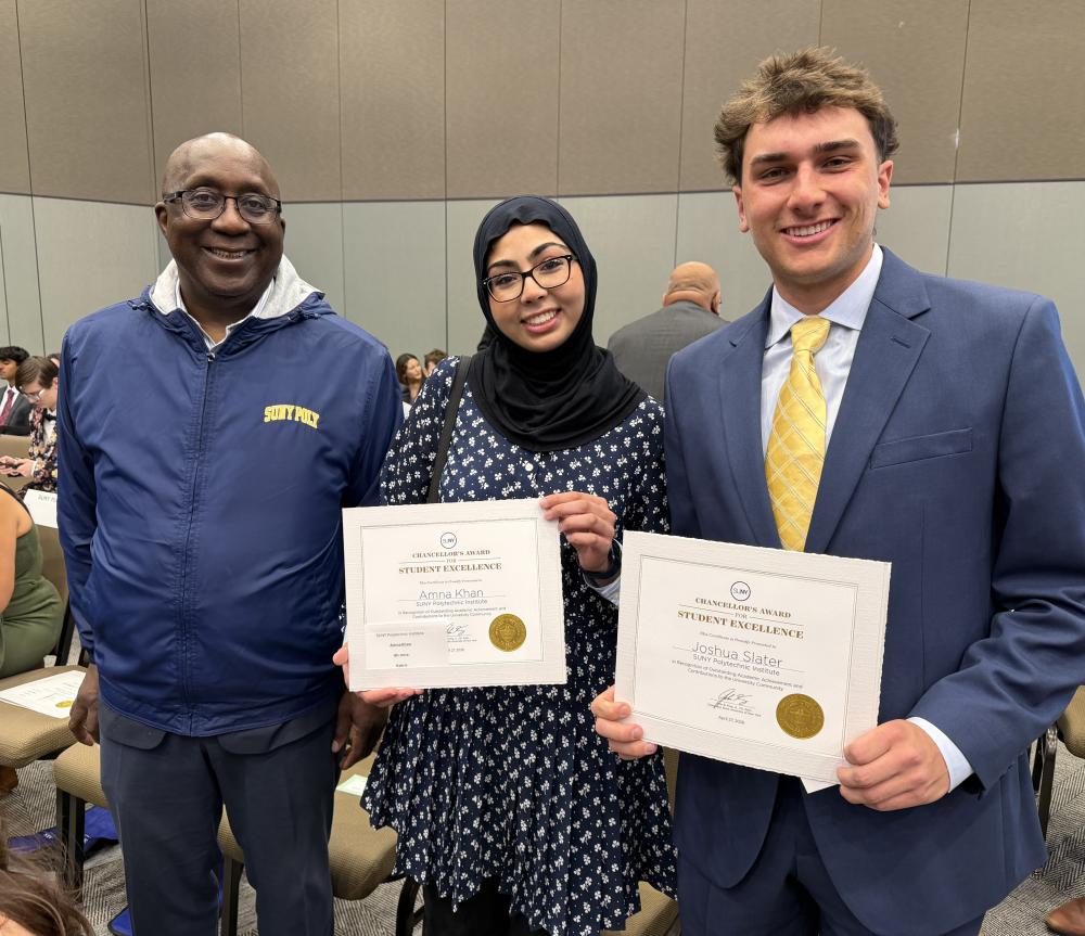 Wole with Amna and Joshua holding up their awards