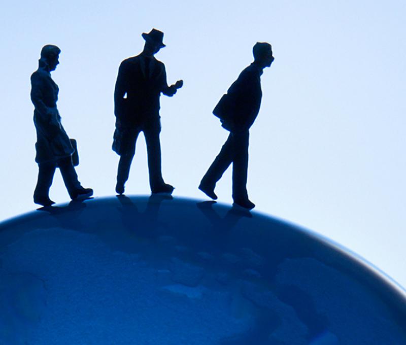 Business Administration - illustrative photo of people walking on globe