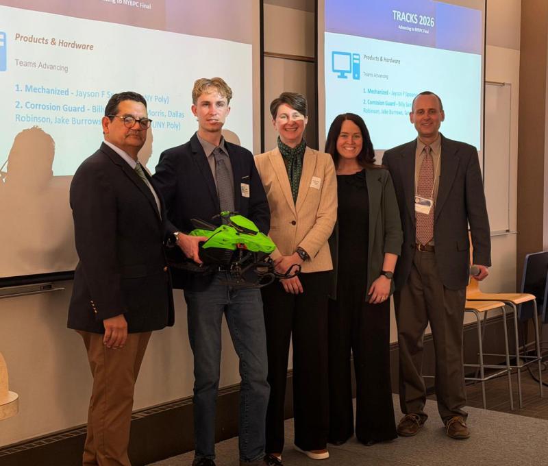 Jayson Spooner of Mechanized with competition judges and College of Business faculty